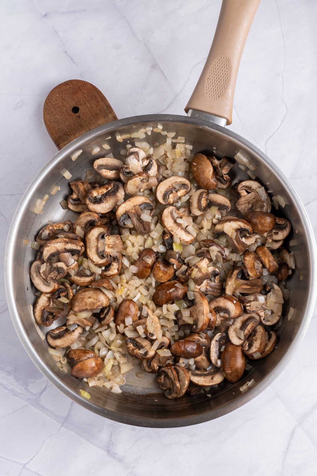 baby bella mushrooms sauteed in a frying pan