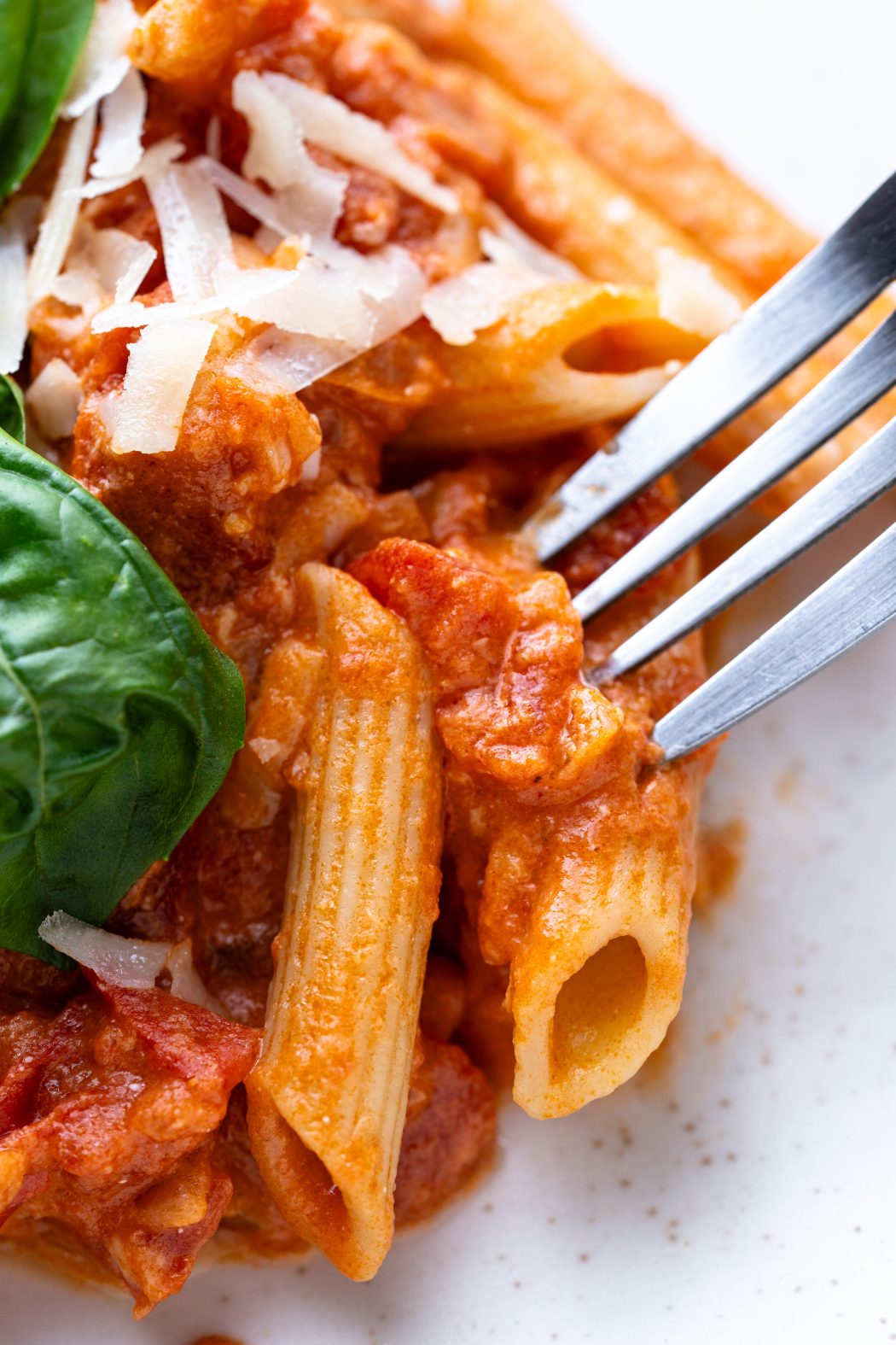 penne pasta with vodka sauce on a plate with a fork