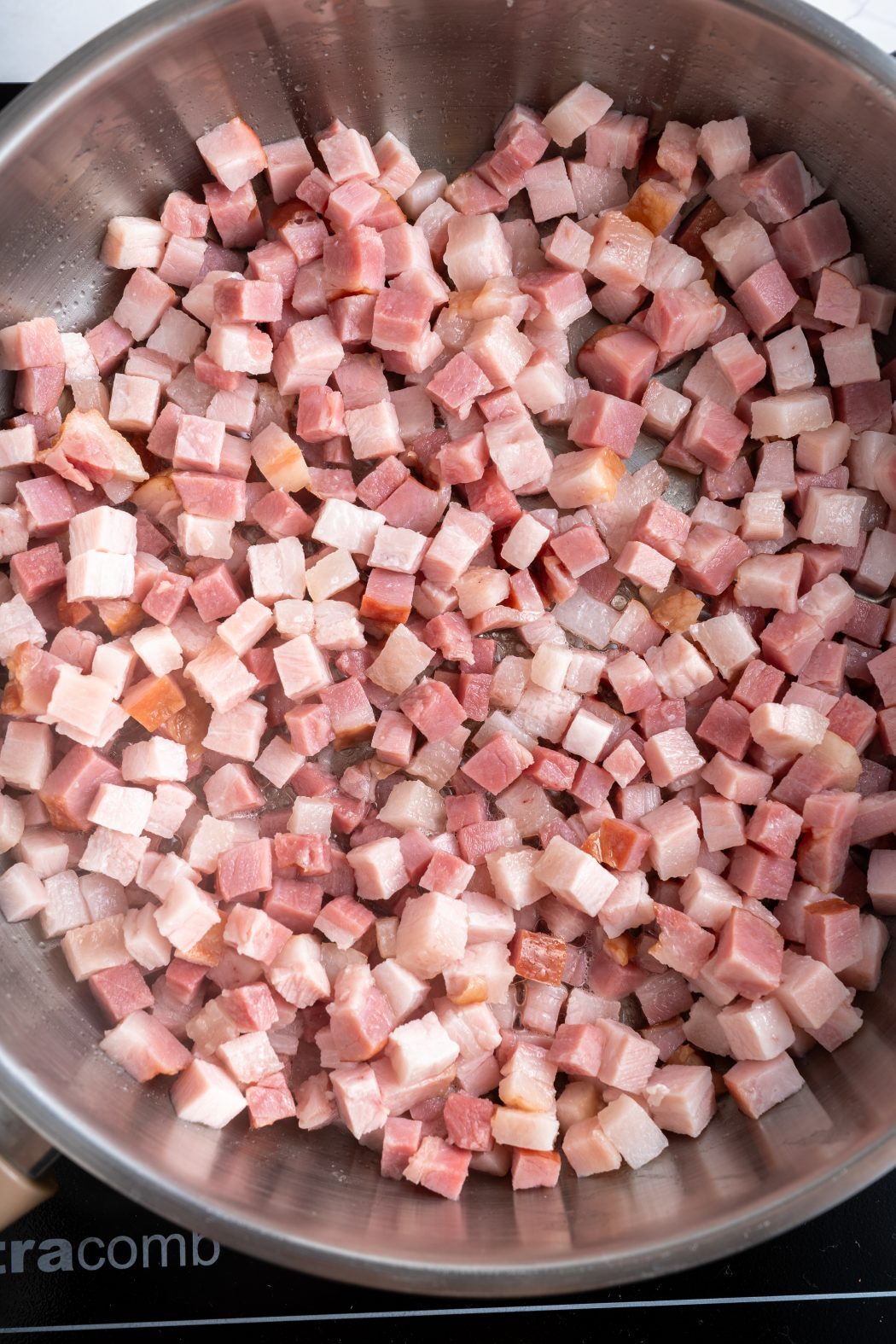 diced bacon in a frying pan