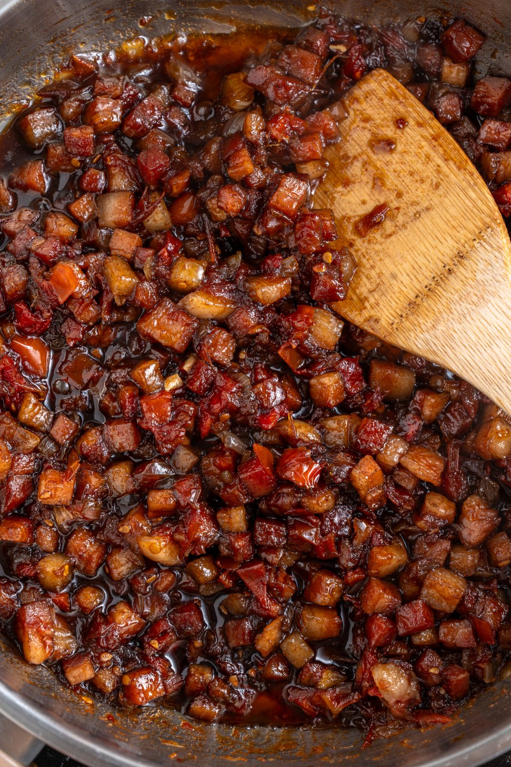 tomato bacon jam ingredients simmering in a pan