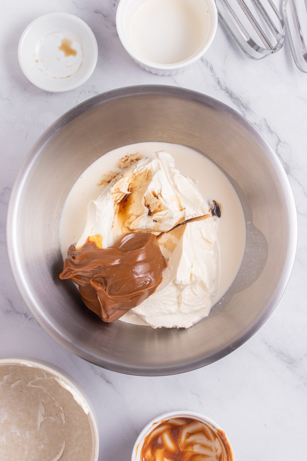 dulce de leche cheesecake ingredients in a bowl