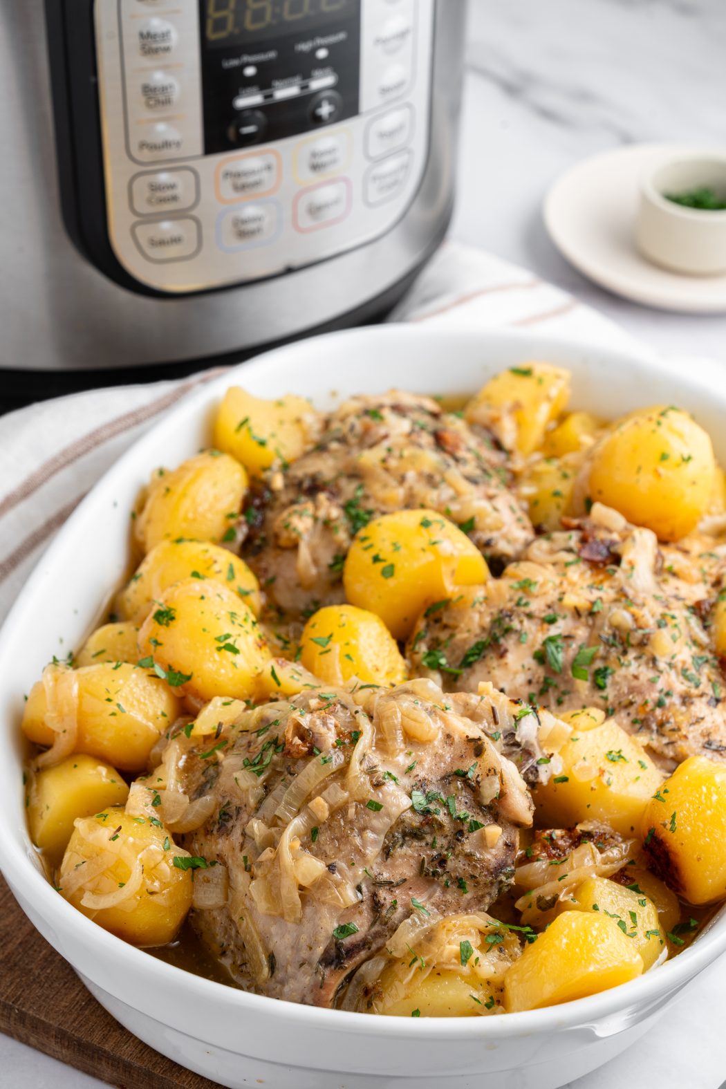 Chicken thighs with potatoes and an instant pot in the background