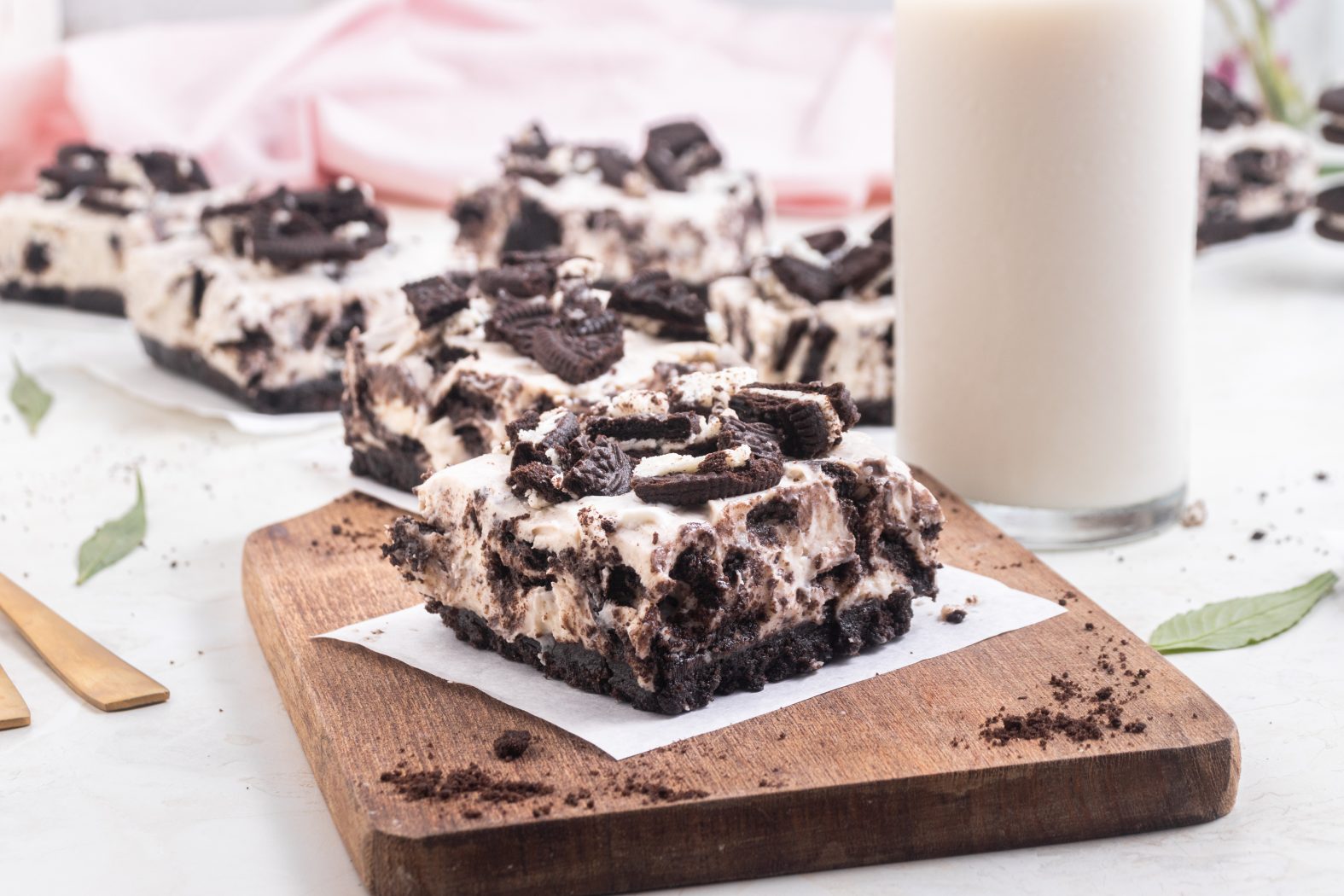 oreo cheesecake bars with a glass of milk