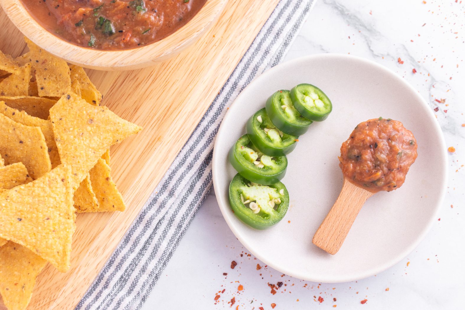 roasted tomato salsa on a plate with jalapeno slices