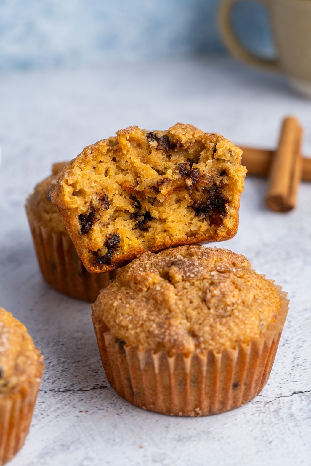 Two almond flour pumpkin muffins with one broken apart