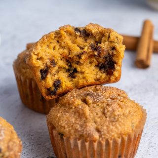 Two almond flour pumpkin muffins with one broken apart