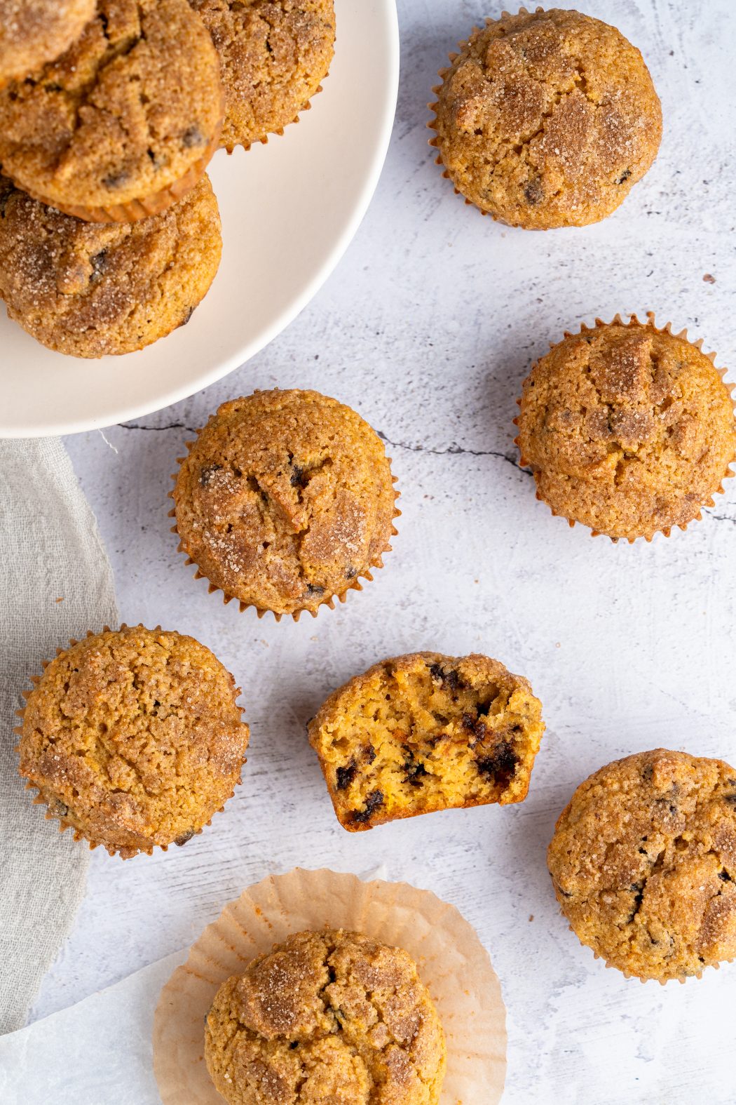 Top view of almond flour pumpkin muffins with one broken apart