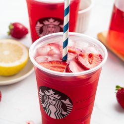 Two Strawberry Açaí Starbucks Refreshers with straws