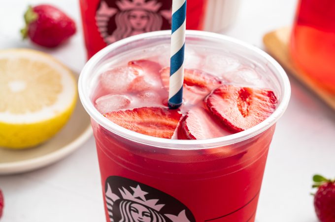 Two Strawberry Açaí Starbucks Refreshers with straws