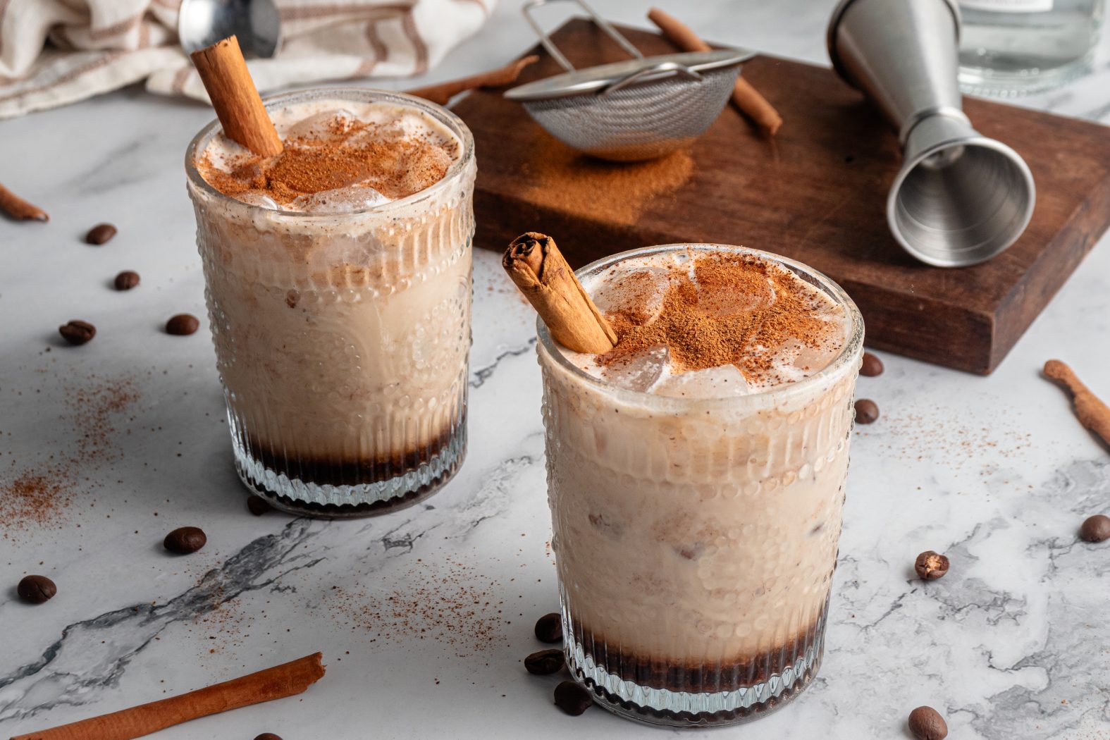 Pumpkin spice white russians garnished with cinnamon