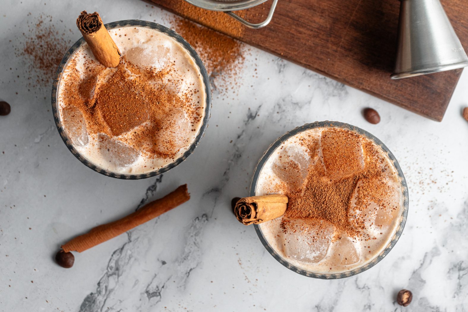 Overhead view of pumpkin spice cocktails with cinnamon