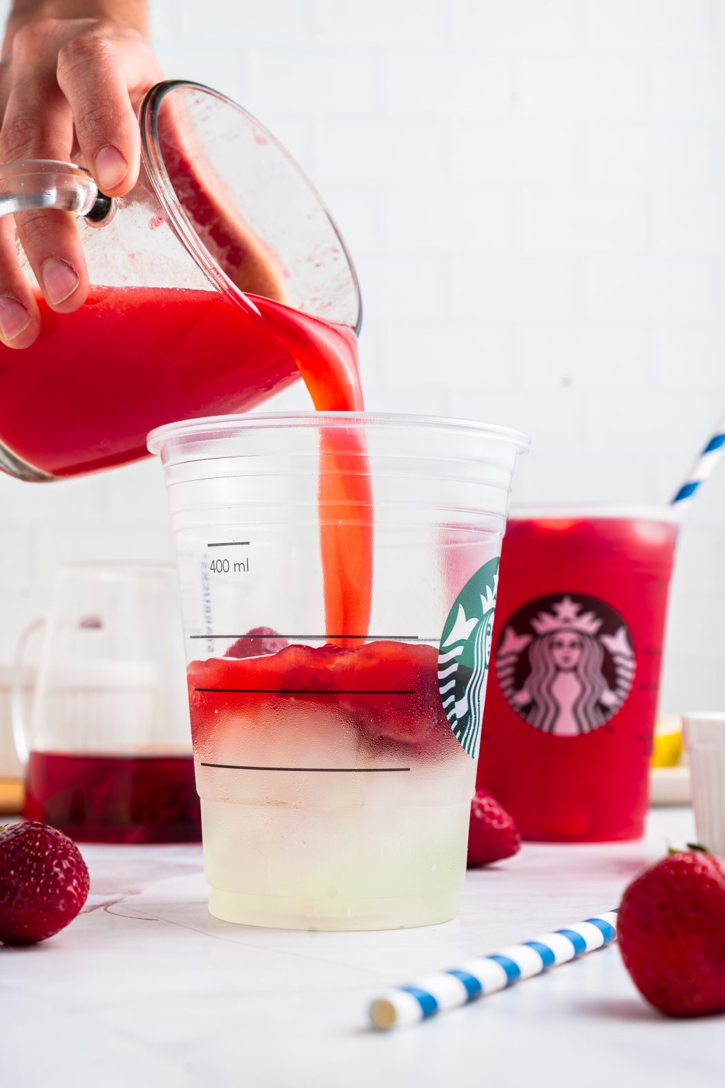 Pouring strawberry juice into a glass